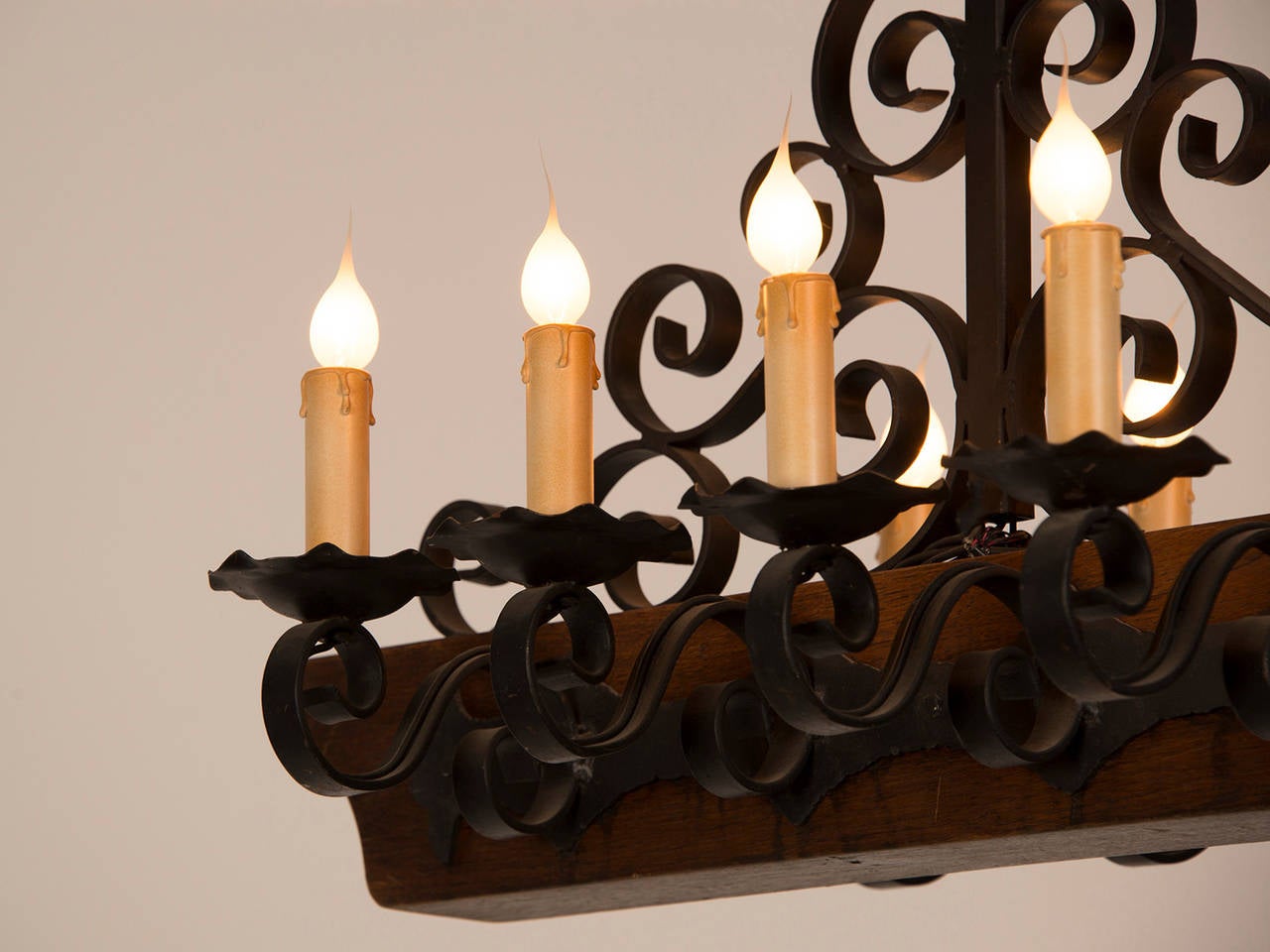 Mid-20th Century Decorative Chandelier with a Wooden Beam and Iron Candle Arms, France circa 1950 For Sale