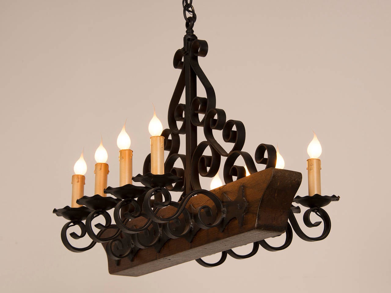 Decorative Chandelier with a Wooden Beam and Iron Candle Arms, France circa 1950 In Excellent Condition For Sale In Houston, TX