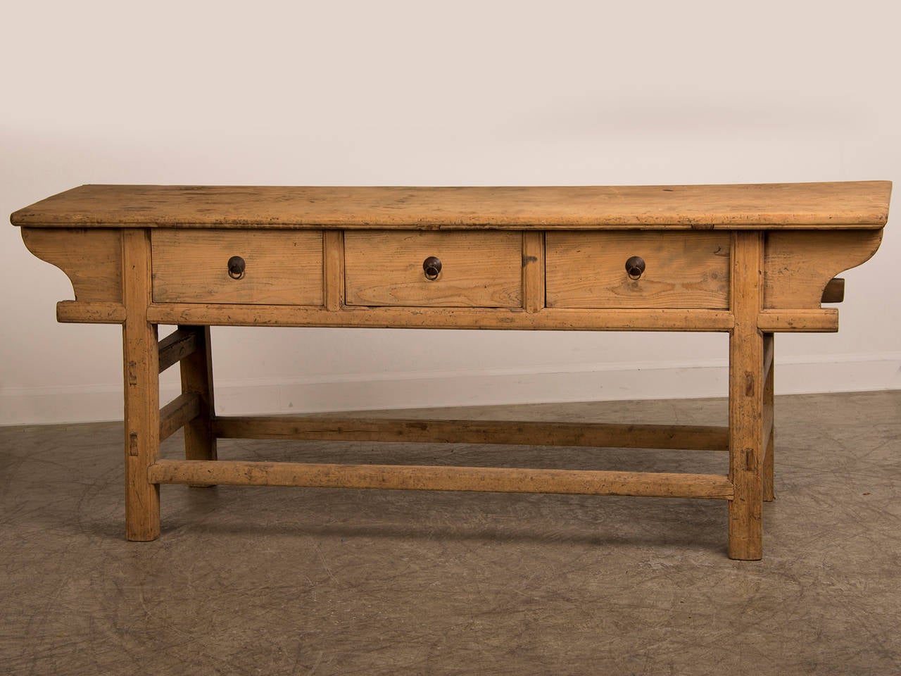 A striking bleached elm serving table from the Kuang Hsu period in China c. 1875. Please notice the architectural simplicity of this piece with the four vertical legs set at a slight slant. Each of the legs are joined by a series of horizontal