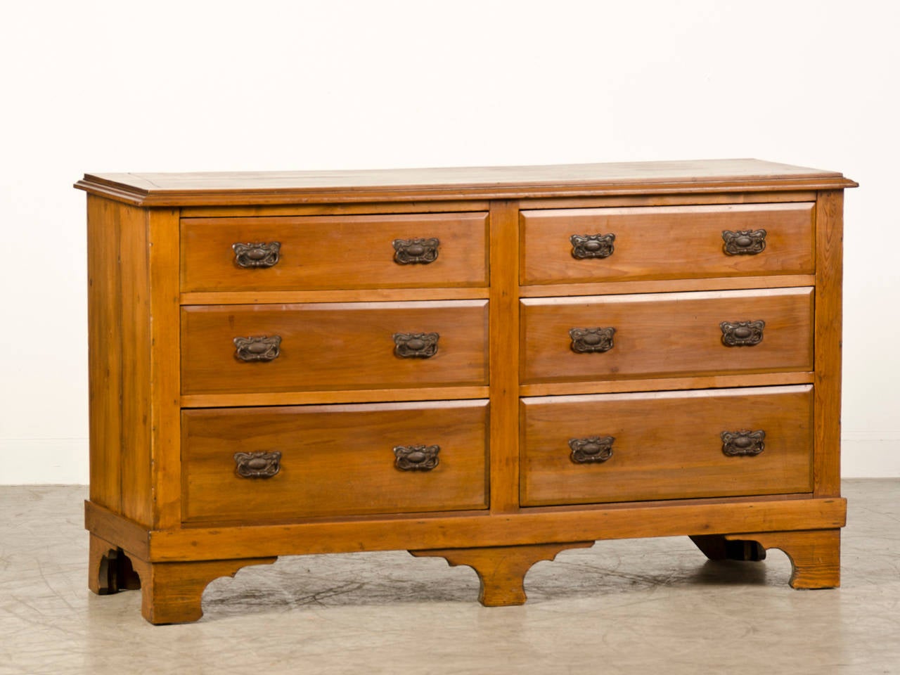 An Edwardian period double wide pine chest of drawers from England c.1910. This is an unusual chest of drawers because of the total of six drawers with three drawers placed side by side. The top of the chest has a handsome moulded edge that extends