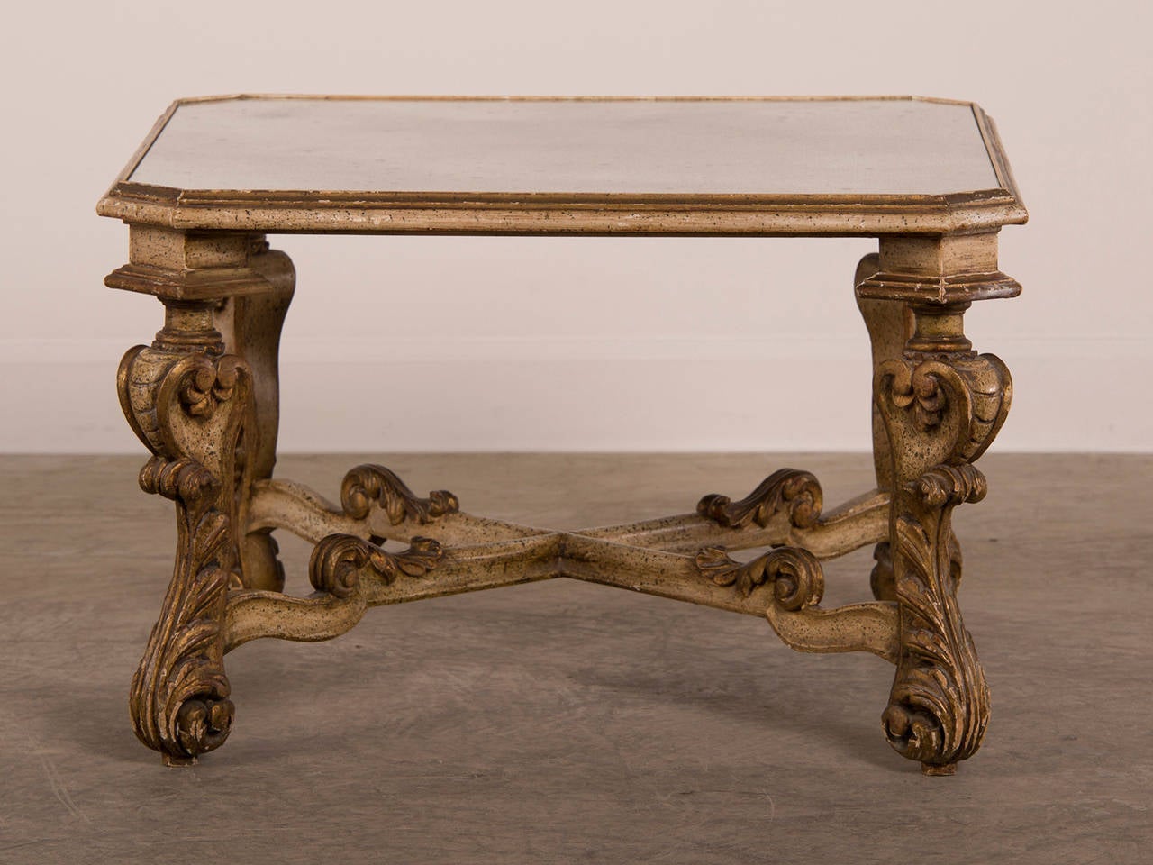 A vintage Baroque style painted and carved wood cocktail or coffee table base with a label 