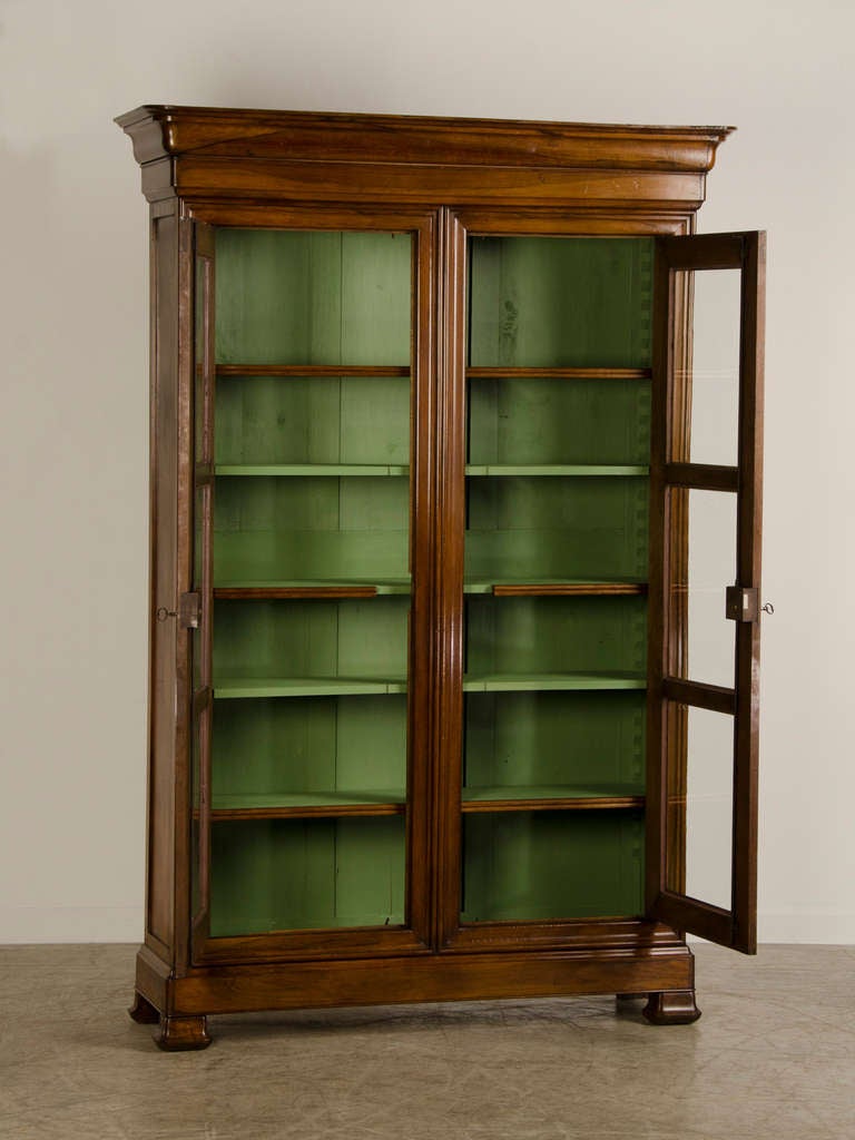 A Louis Philippe style walnut bibliotheque of superb proportions and timber from France c. 1870. Please take a moment to examine the excellent quality of the lustrous walnut that this bibliotheque is constructed from as well as its splendid