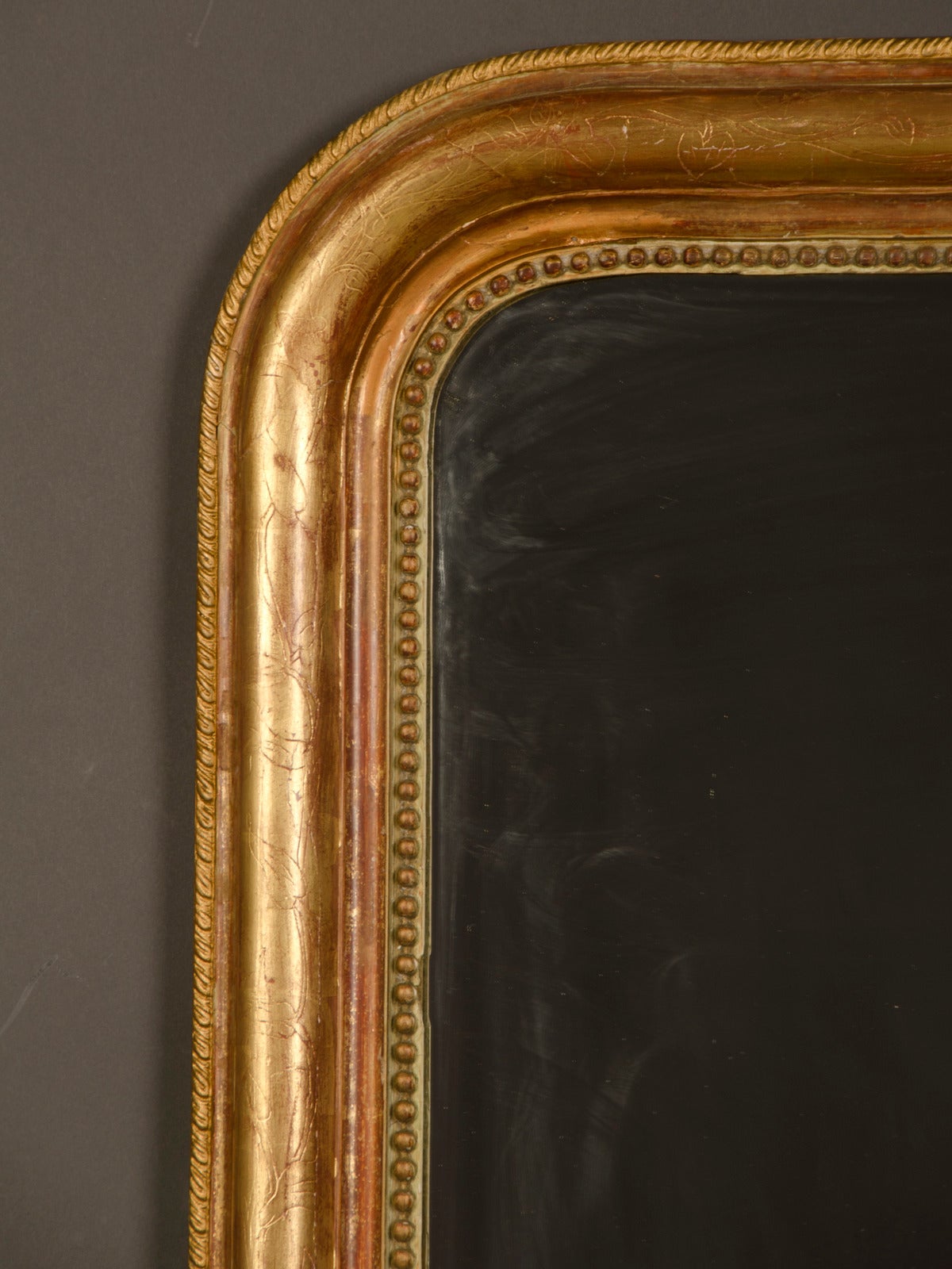 A Louis Philippe style gold leaf frame that encloses the original mirror glass from the Belle Epoque period in France circa 1890. This is a perfect example of the type of mirror and frame so popular in late nineteenth century France. The simplicity