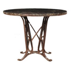 Iron base dining table with a marble top from France c. 1890