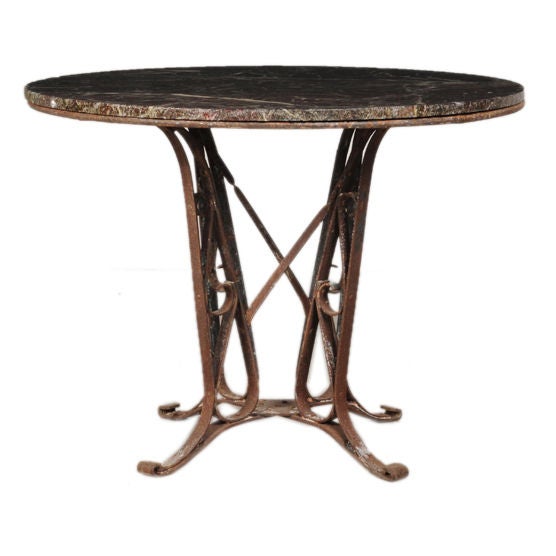Iron base dining table with a marble top from France c. 1890
