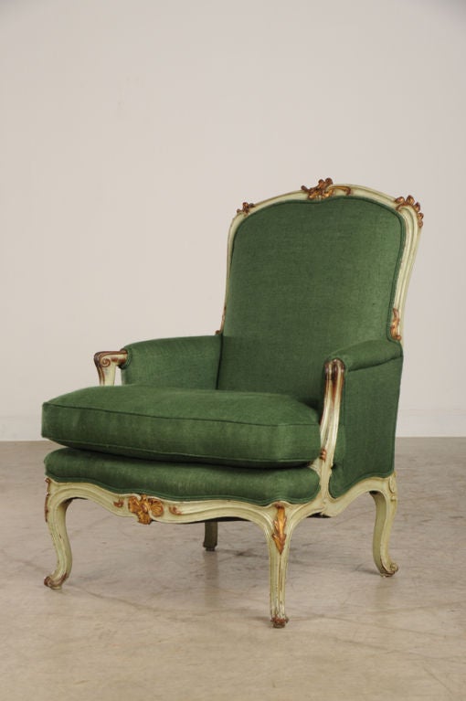 A gorgeous Louis XV style bergere from France c. 1850 retaining its original gilded and painted finish. Please notice the curvaceous form Rococo design that originated in the mid seventeen hundreds in France. The term 