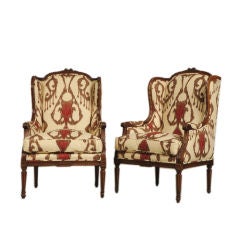 Pair of walnut Louis XVI style bergeres from France c. 1890