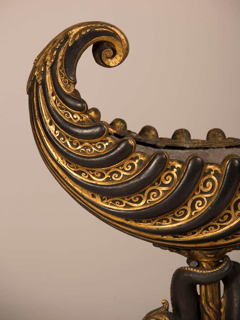 A Napoleon III period gilt and patinated metal table top jardiniere of extraordinary size featuring an open seashell basin with a lead liner on a dolphin base from France c.1870. The form of an open boat or 