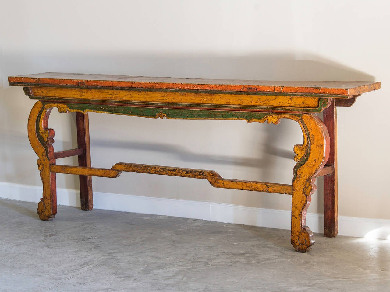Painted and Carved Altar Table, Yunnan Province, China c.1890. The brilliant colours of yellow, green and red seen here correspond to specific attributes in Chinese culture as well as the Buddhist religion which spread northward from Tibet. Given