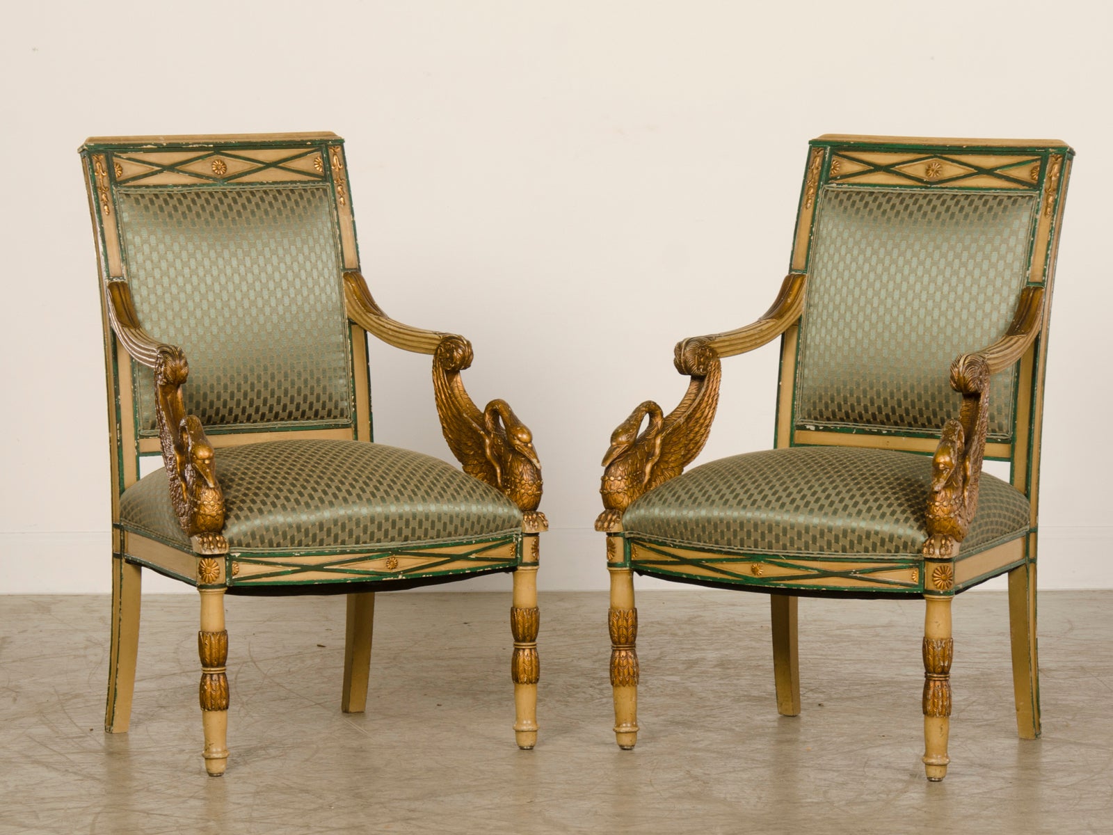 Empire period pair painted and gilded arm chairs from France c.1810