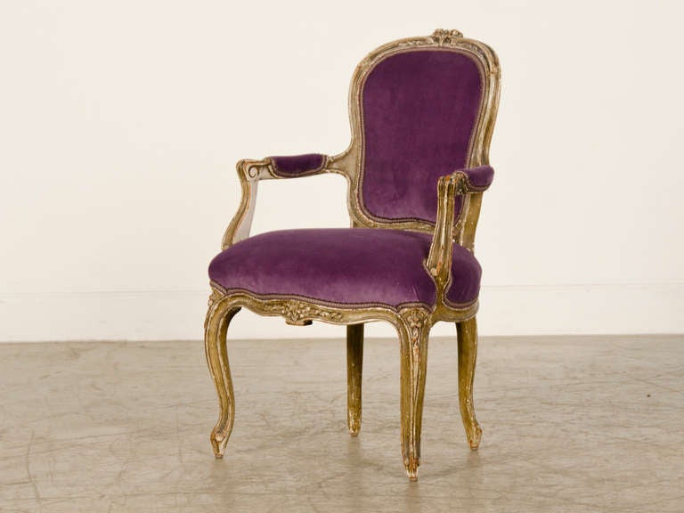 A fabulous Louis XV style child's fauteuil (armchair) with the original painted finish from France c.1865. This chair has the beautiful flowing lines of the style immortalized under the reign of Louis XV (1723-1774) that are reminiscent of the