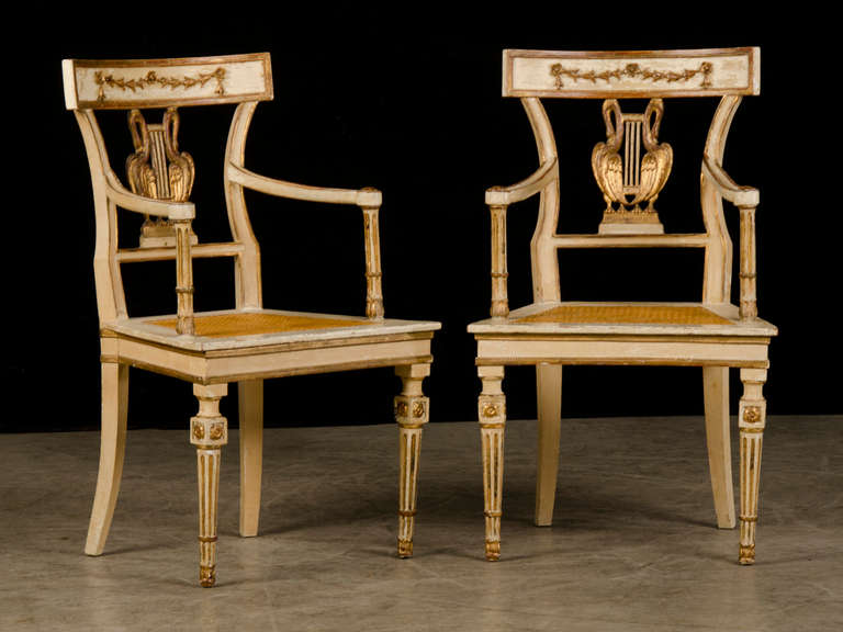A pair of beautifully painted Neoclassical style armchairs from Italy circa 1875. These elegant armchairs epitomize the combination of symmetry and balance that defines the continuing allure of neoclassicism that swept through Europe at the end of