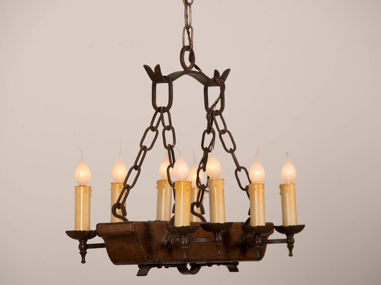 Receive our new selections direct from 1stdibs by email each week. Please click Follow Dealer below and see them first!

A vintage French eight-light wooden beam chandelier circa 1940 having substantial ironwork.