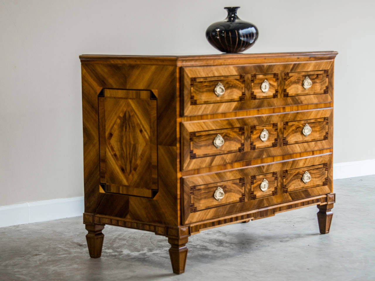 Louis XVI Period Inlaid Walnut Chest of Drawers, South Germany c.1785. The extraordinary pattern of inlay visible on the top, front and both sides of this three drawer chest is entirely neoclassical in nature. The attention to geometric precision in