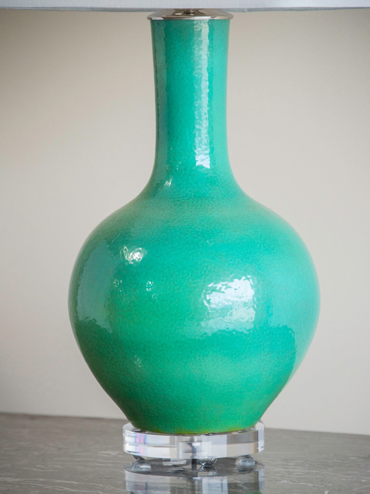 Turquoise Chinese vase mounted on a Lucite base as lamp.