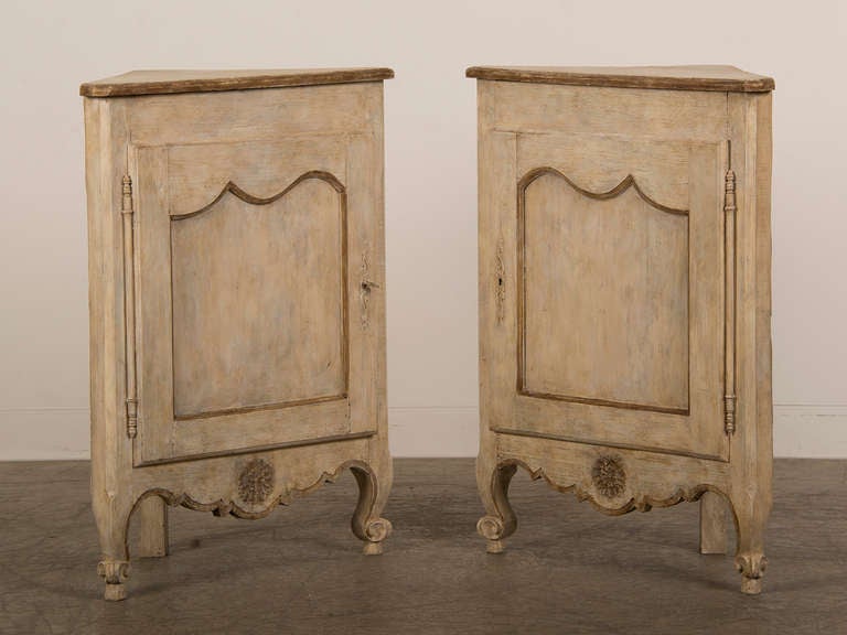 A pair of Louis XV style corner cabinets with antique doors from France c.1850 now with an elegant painted finish. These charming cabinets have been assembled into a pair of corner cabinets by rescuing the pair of antique doors and setting them into