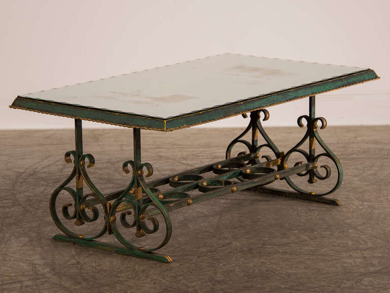 Painted, Gilded Iron and Mirror Coffee Table, France c.1920. The handsome symmetry of the pattern makes this substantial iron coffee table especially desirable. Each vertical end support has a matching lyre pattern section standing upon a solid