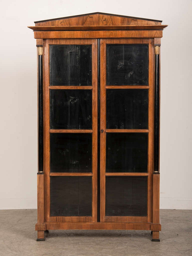 Empire style walnut vitrine having ebonized columns, Austria c.1890 In Excellent Condition In Houston, TX