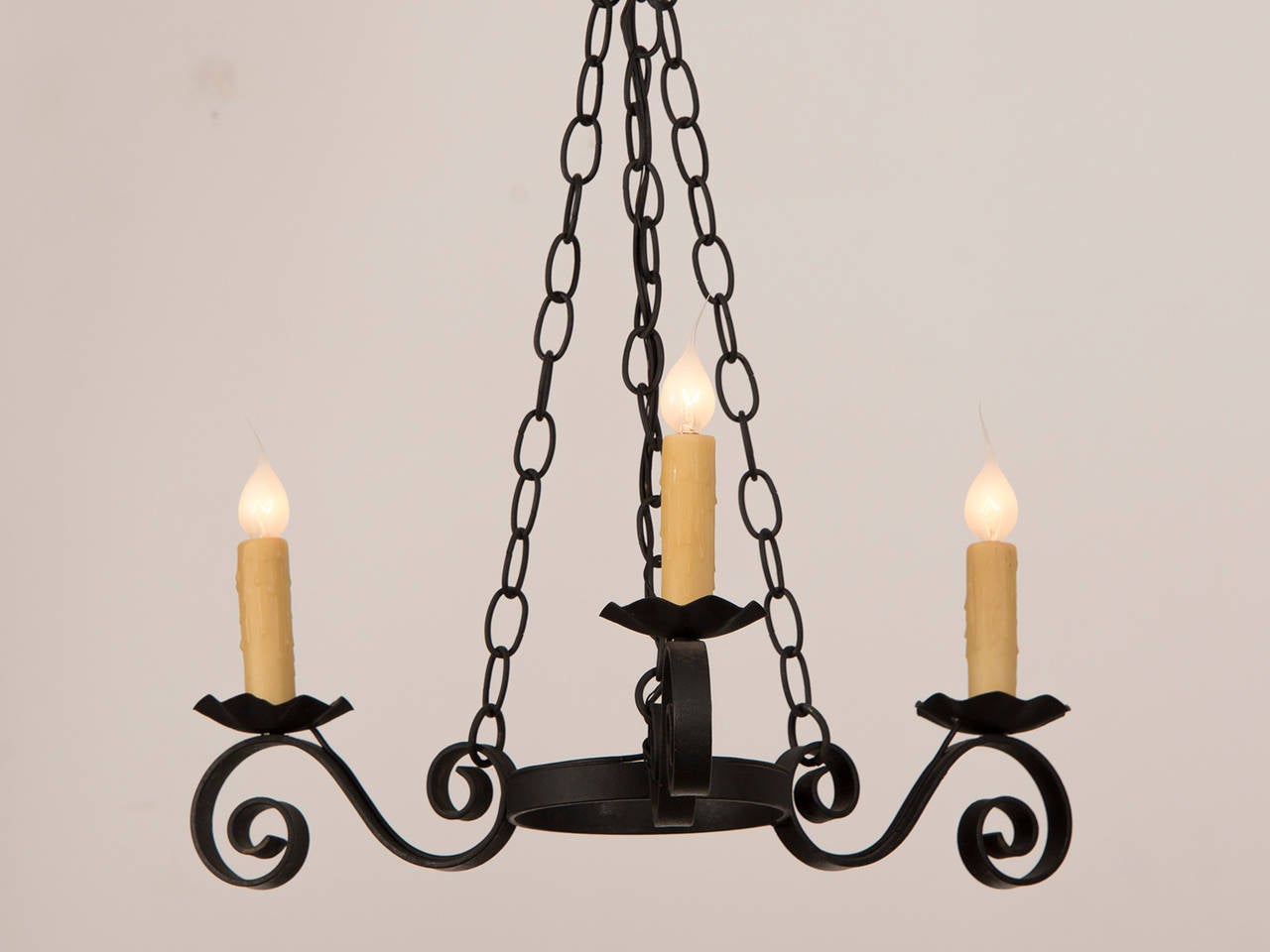 Receive our new selections direct from 1stdibs by email each week. Please click Follow Dealer below and see them first!

A vintage French three arm iron chandelier circa 1950 with a black painted finish. This fixture has been wired for America and