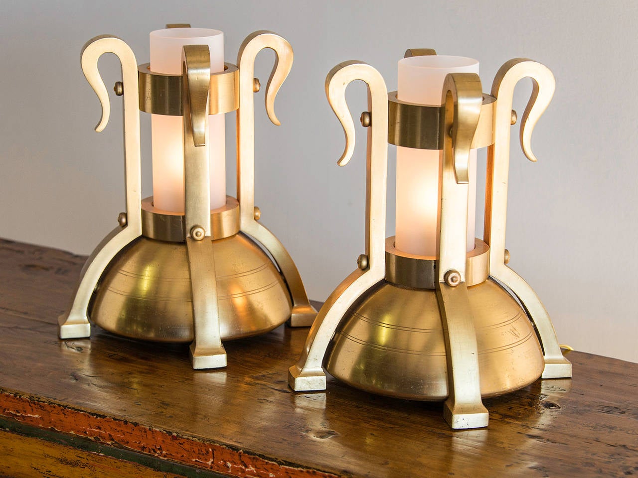 A pair of Art Deco period bronze doré fittings from Italy c. 1930 mounted as custom lamps. The gold washed bronze creates a highly luminous effect and the substantial weight is immediately apparent upon lifting each piece. The half spherical base