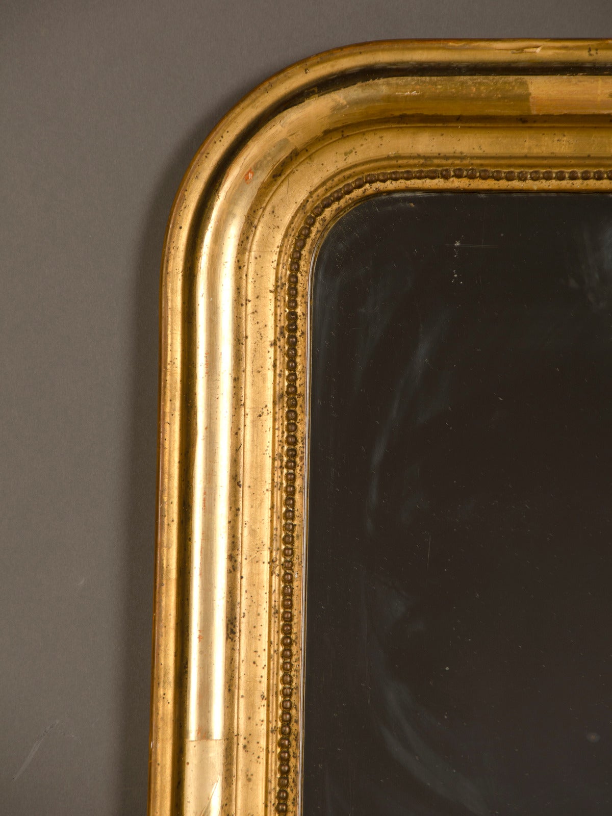 A handsome Louis Philippe style gold leaf frame enclosing the original mirror glass from Belle Epoque period  France c.1895. Please take a moment to use the zoom feature on our website to enlarge all the provided photographs to see the wonderful