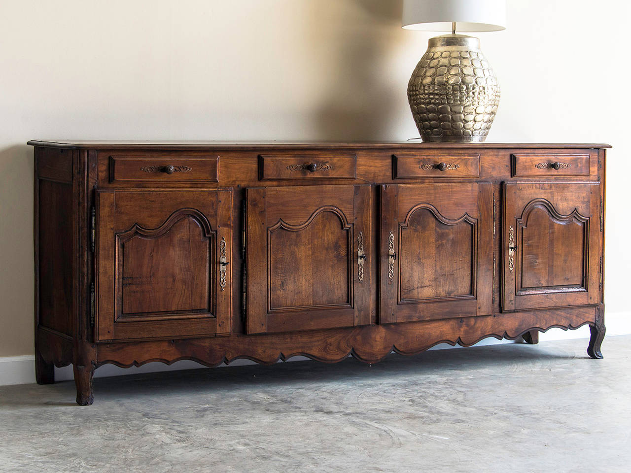 Louis XV Style Walnut Enfilade, France c.1875. The luminous colour of the walnut and the elegant balance of the four cabinet doors that each have a drawer above combine to make this piece of French cabinetry quite desirable. The facade of this