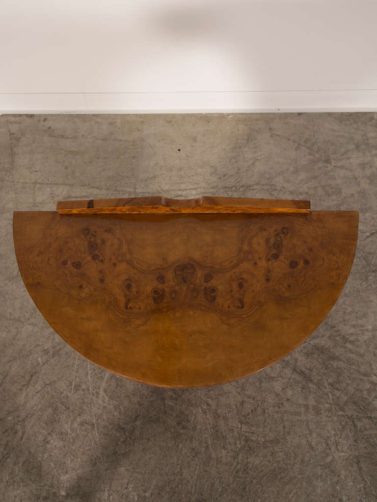 An Art Deco period burl walnut console table of striking form from France c.1930. The exceptional balance of the proportions on this console as well as superb quality of the timber give it an impressive appearance. There is an inherent tension