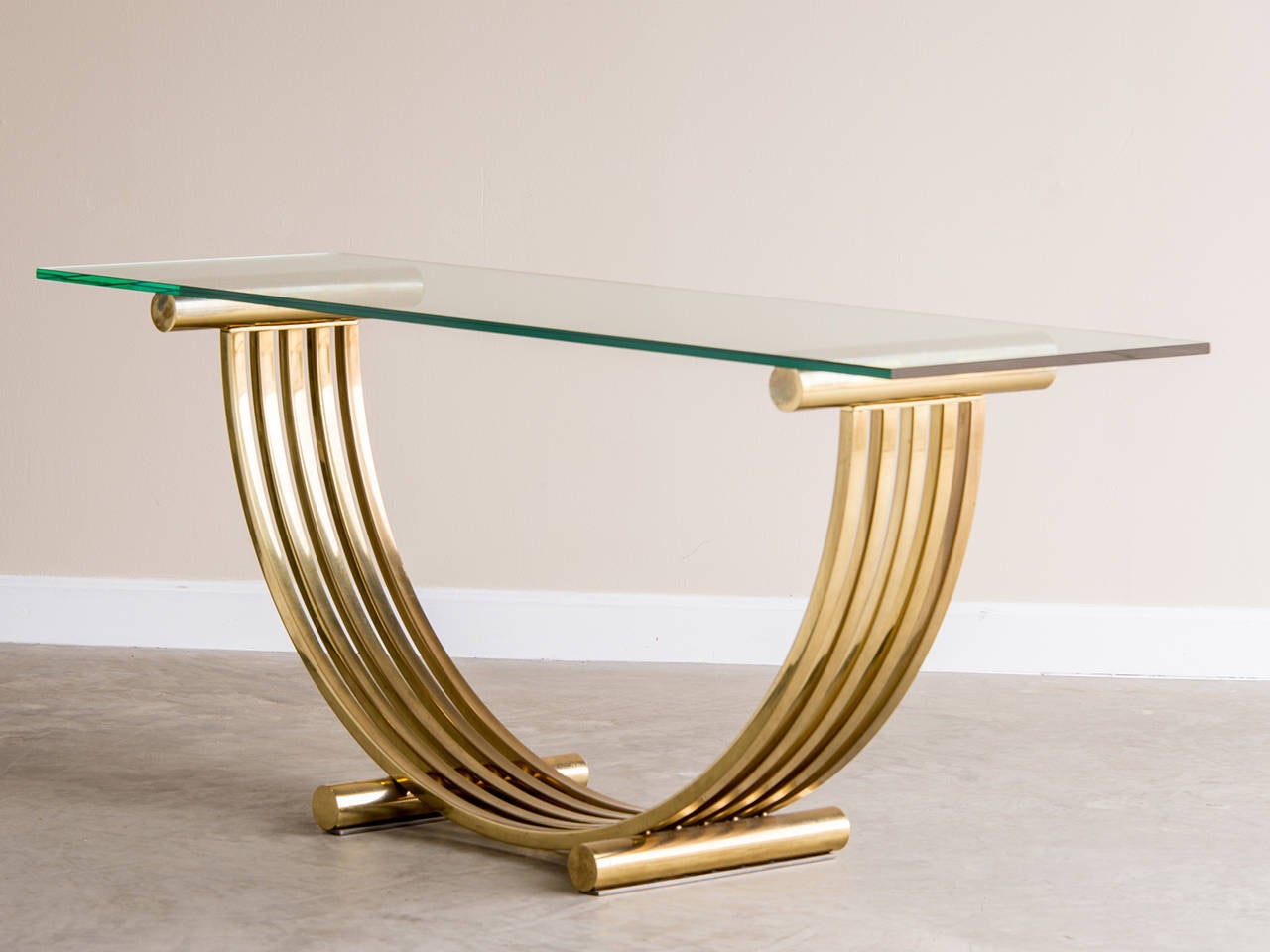 Romeo Rega Mid Century Modern Brass Console Table, Italy circa 1965, Glass Top. This dramatic table employs the strength of a geometric half sphere curve standing on cylinder supports to achieve its powerful visual effect. The curve itself is made