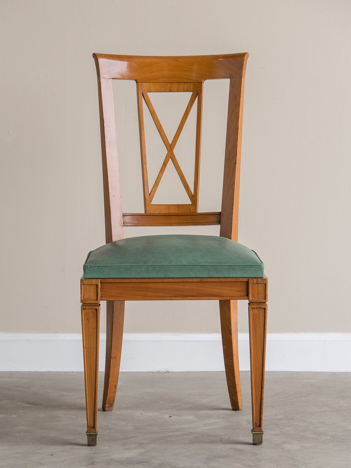 French Art Deco set six cherry chairs, France, circa 1930. The tall and slender lines of these chairs conjures up the power of neoclassical taste developed at the end of the 18th century when refinement and purity of detail were paramount values.