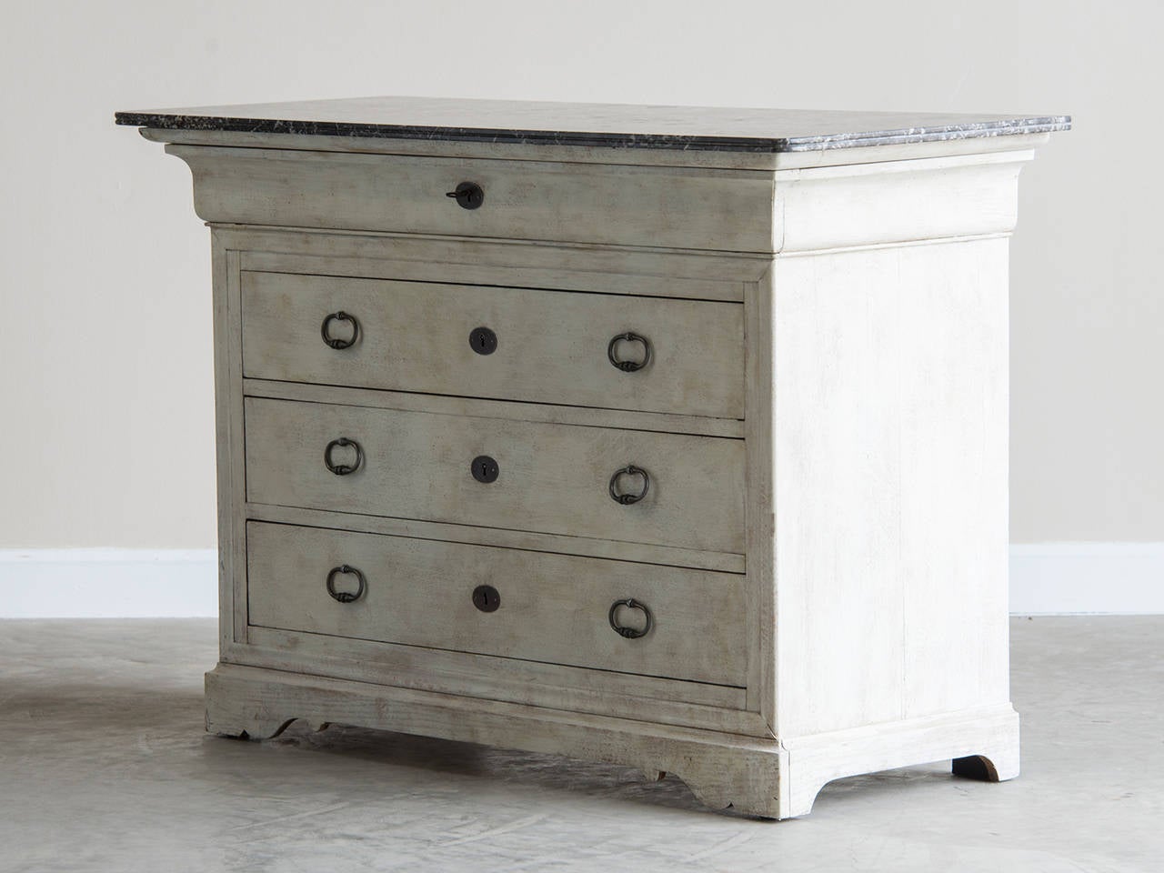A Louis Philippe style pale oak chest of drawers from France c. 1865 with a marble top.