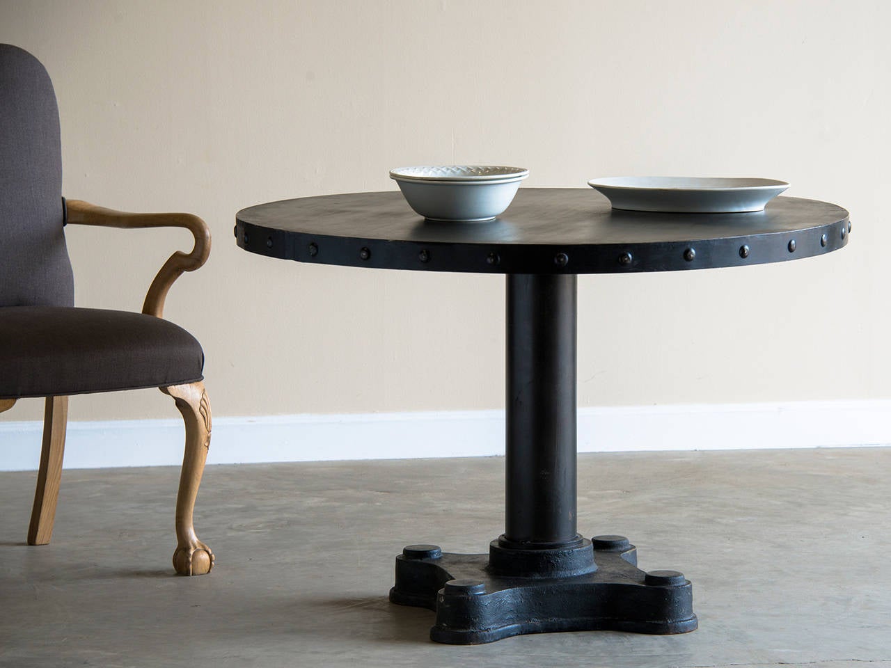 This table is perfectly circular and stands upon an Industrial base made of solid iron from Holland, circa 1960 salvaged from a derelict warehouse. Because the materials used are solid iron and steel this table is heavy as well as being virtually