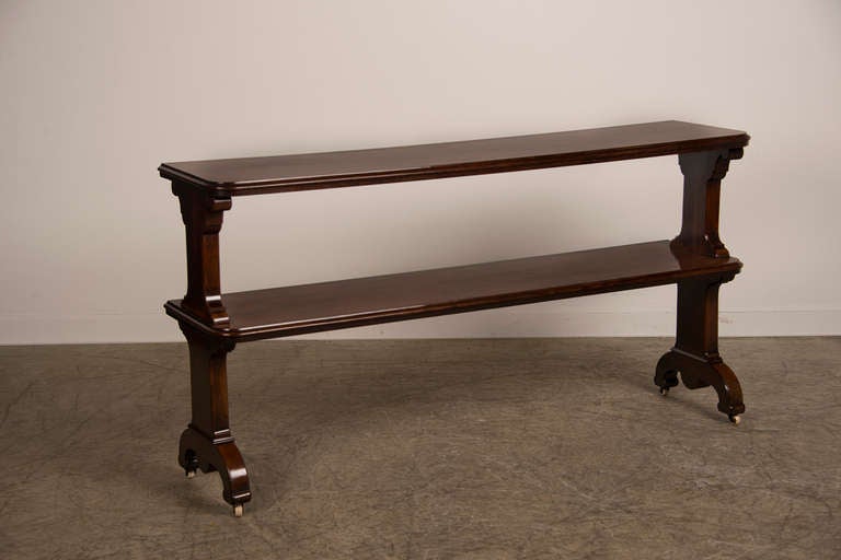 Mahogany Two Shelf Server, Original Casters, Ireland c.1870. The bold scale and solid material on this unique server table give this piece a modern sculptural appeal.