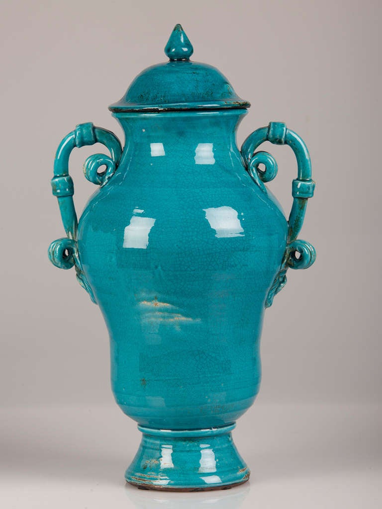 Burmantofts style pair of blue glazed terra cotta urns with lids, England c. 1920.