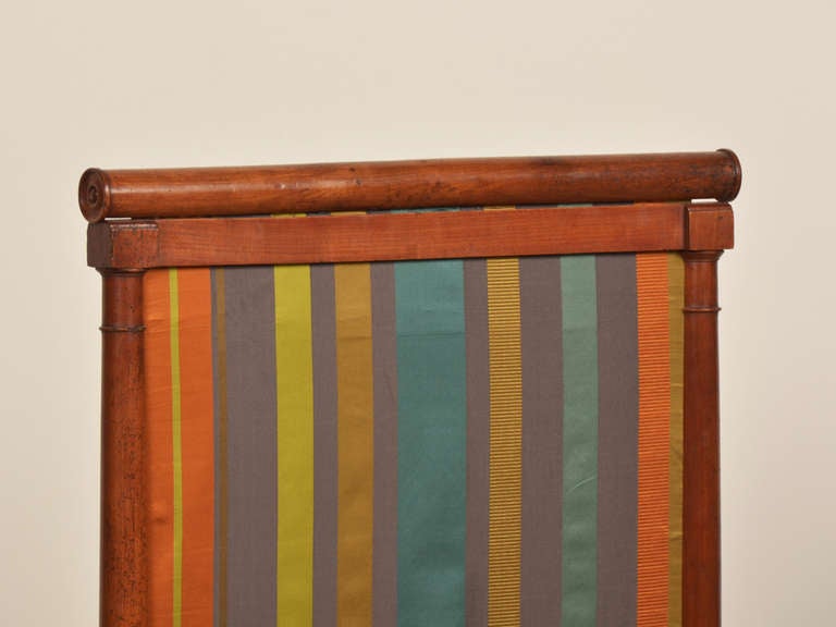 Receive our new selections direct from 1stdibs by email each week. Please click Follow Dealer below and see them first!

An antique French Directoire period walnut fire screen with a removable frame now covered in a striped silk from Brunschwig