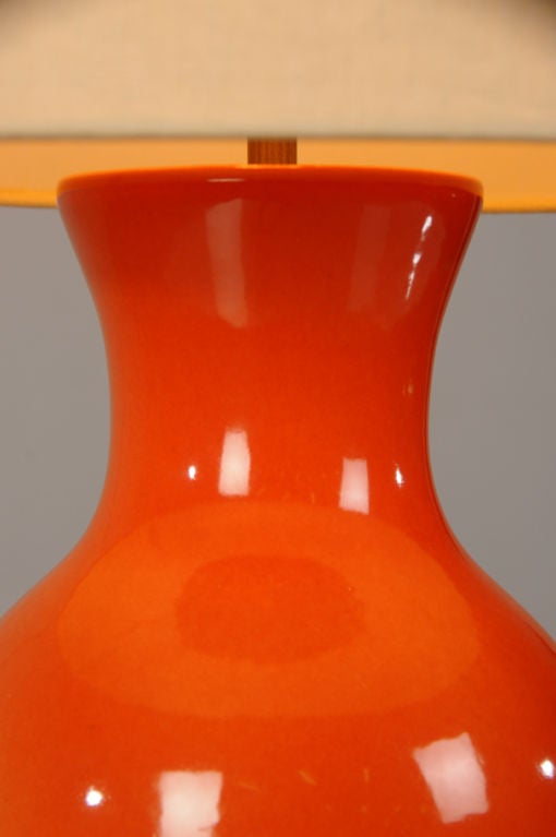 A classically shaped vintage vase in a gorgeous orange glaze from France c. 1950 mounted as a lamp and wired for American electricity. Please notice the elegant taper of the shape that begins with a flared rim before it moves in and flares back out.
