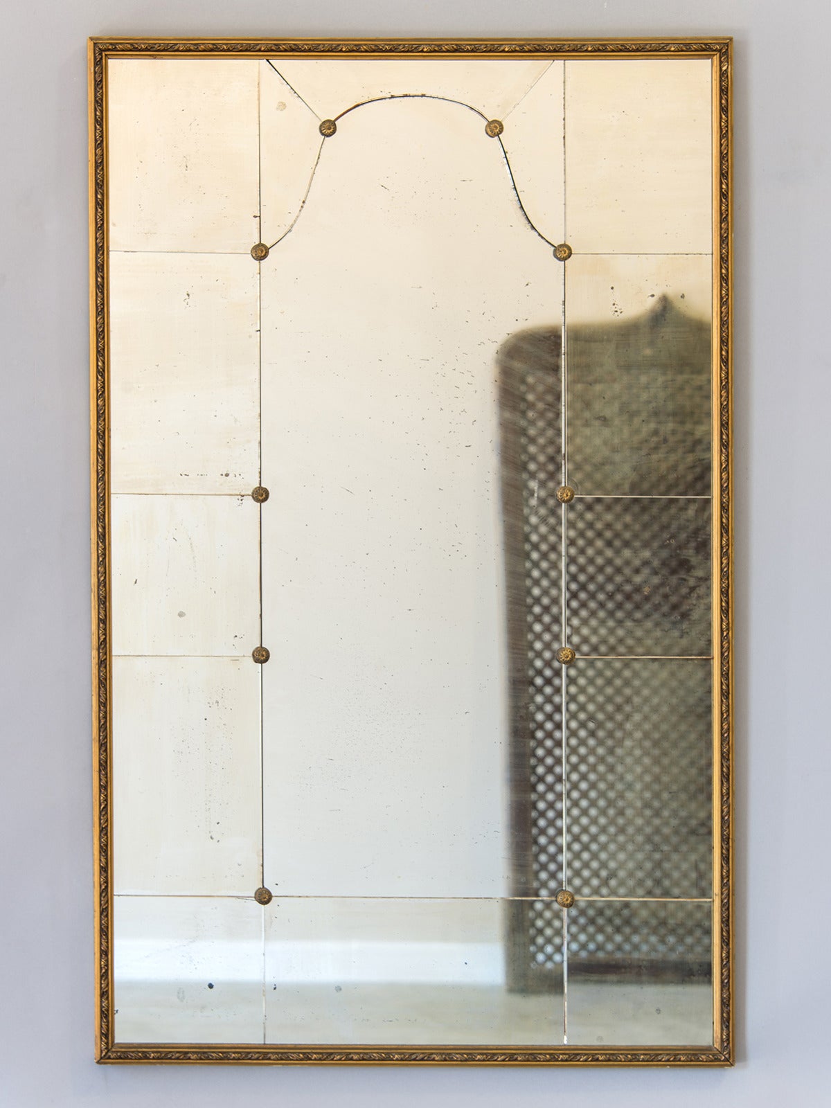 Vintage Mid Century Gilt Framed Mirror, France c.1950. The lovely arch seen within the mirror glass on this piece results from the individual plates of mirror cut and shaped to create a unique pattern. Between each mirror plate is a circular