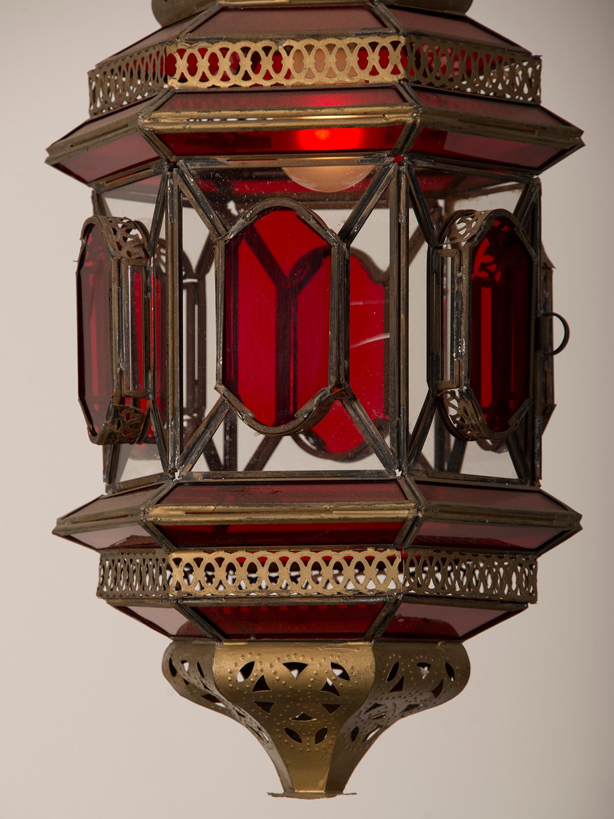 Mid-20th Century Moroccan Lantern circa 1940 Enclosing Ruby and Clear Glass with Filigreed Brass