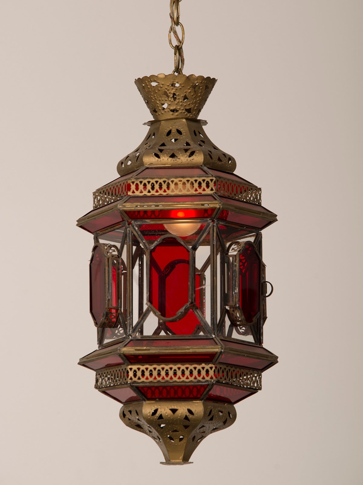 English Moroccan Lantern circa 1940 Enclosing Ruby and Clear Glass with Filigreed Brass