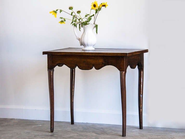 Louis XV Period Walnut Side Table, France circa 1760. This provincial table was originally designed and constructed to be used in the centre of a room as it is entirely finished on all four sides. The gentle curve of the cabriole legs reveals that