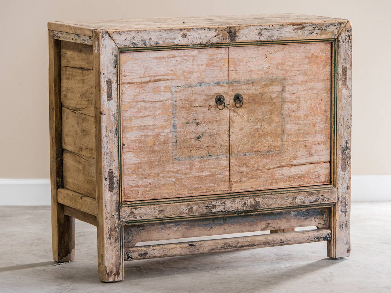 This charming cabinet has a pair of cabinet doors recessed into a framed opening with the entire exterior retaining traces of the original painted finish. Always built to sturdy specifications the mark of hand construction is quite evident
