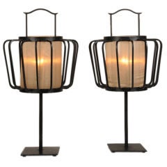 A pair of tall contemporary iron table lamps