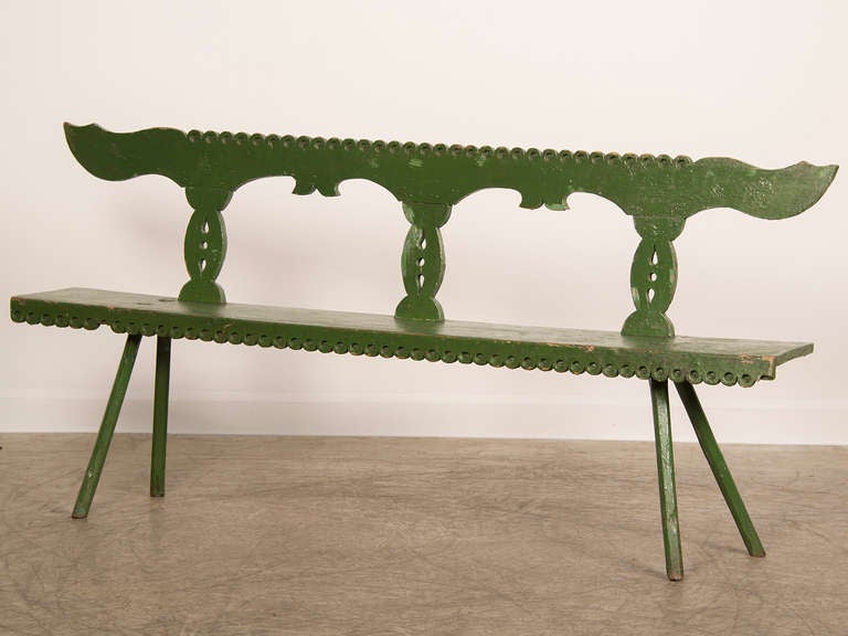 A striking bench with the original painted finish from Romania c. 1875. This bench possesses an elegant and attenuated line that imbues it with surprising modern energy. Originally this bench was made for a position near the front door of a rural
