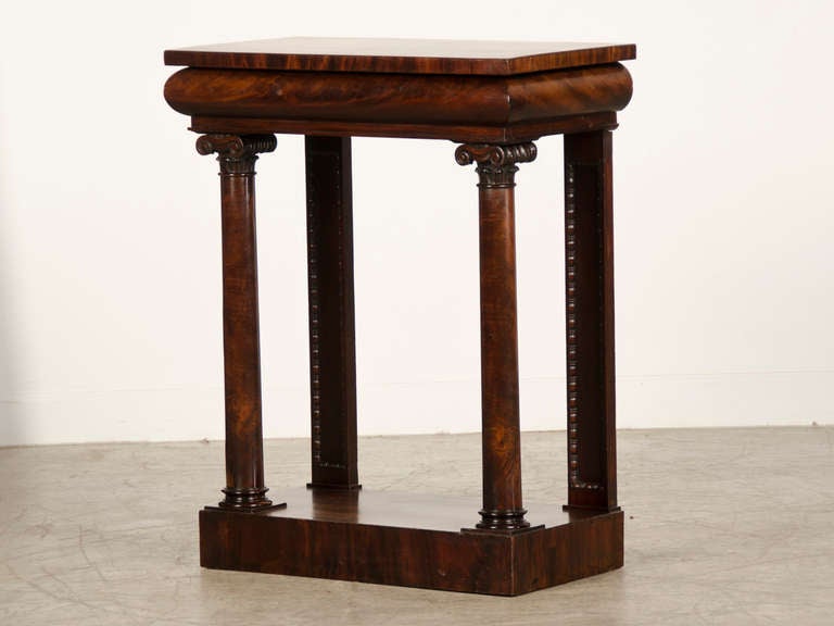 An English William IV period mahogany console table with a concealed drawer circa 1835. The design of this superb console table features a bold profile and the original design indicates its prominent placement in an interior where it would be seen