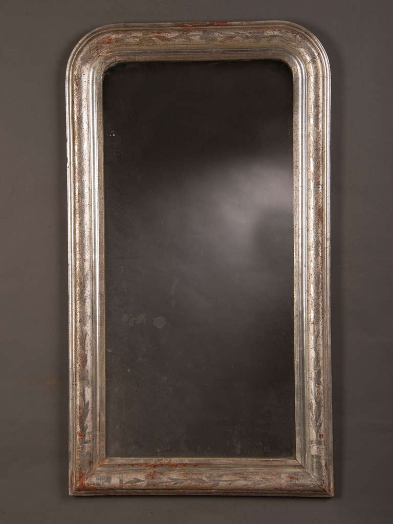 Silver Gilt Louis Philippe Framed Mirror, Belle Epoque Period France c.1895. The beautiful patina of this frame reveals the red gesso layer beneath the silver gilt that enhances the antique quality of the piece. Please note the lovely fogged