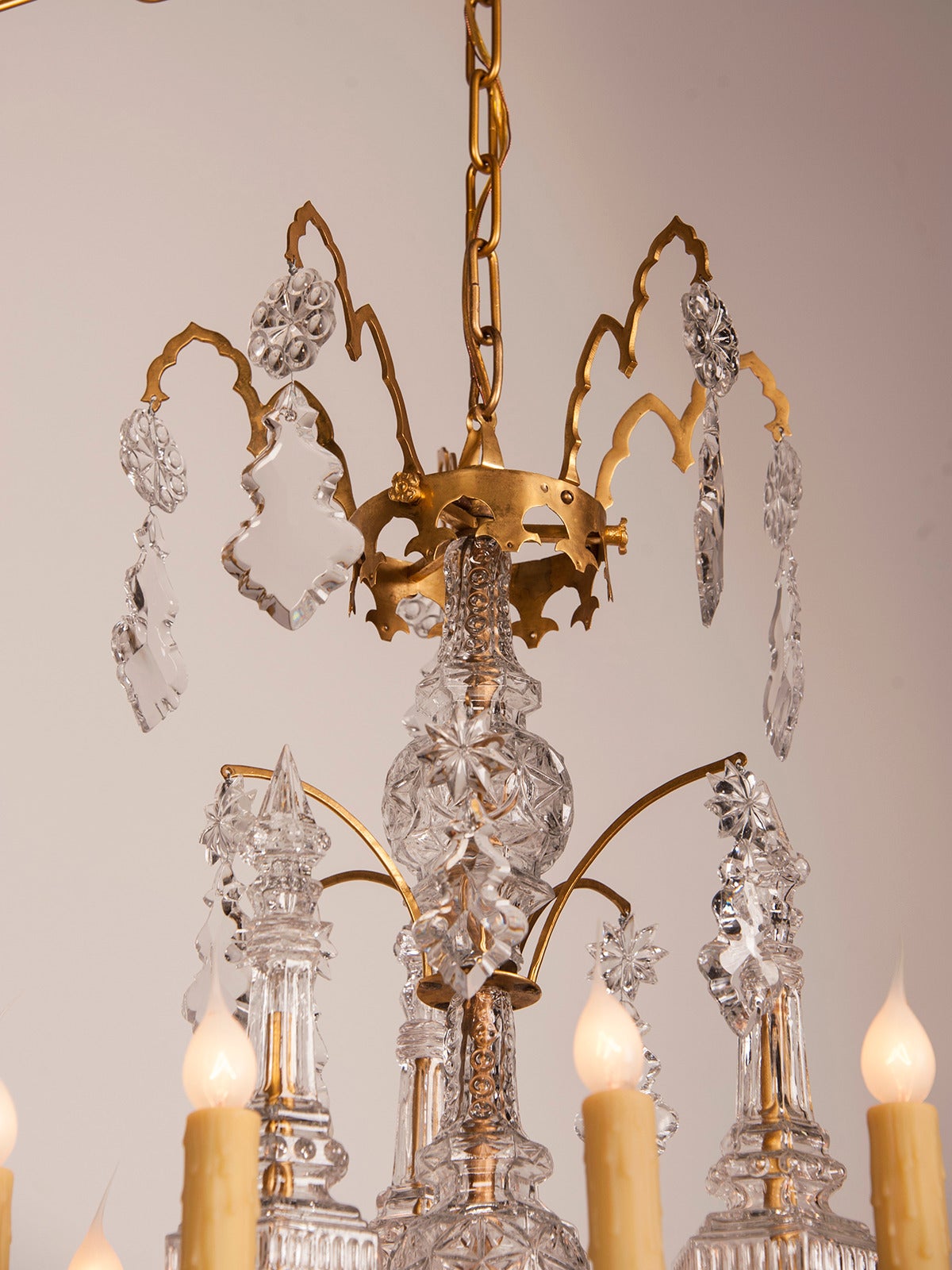 A gorgeous ten-arm gilded bronze antique French Louis XV style crystal chandelier from France circa 1875 affixed with an abundance of crystal and glass pendants. This antique French chandelier has a unique appearance because of the use of highly