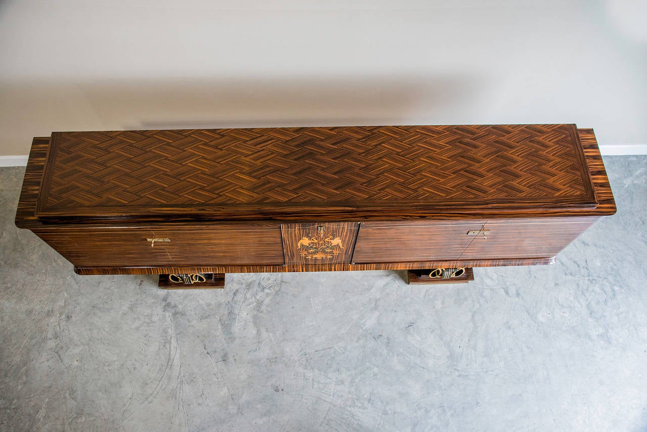 This important vintage French Art Deco period Macassar ebony buffet credenza cabinet from France circa 1930, designed by the famed Jules Leleu, also incorporates gilded iron work in the style of master Gilbert Poillerat from Toulouse. The