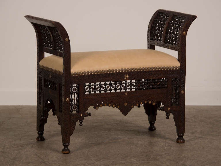 Carved walnut bench inlaid with mother-of-pearl from Damascus, Syria c. 1890. This exceptional bench combines all of the skill and enchantment offered by late nineteenth century furniture created in Damascus. The combination of excellent