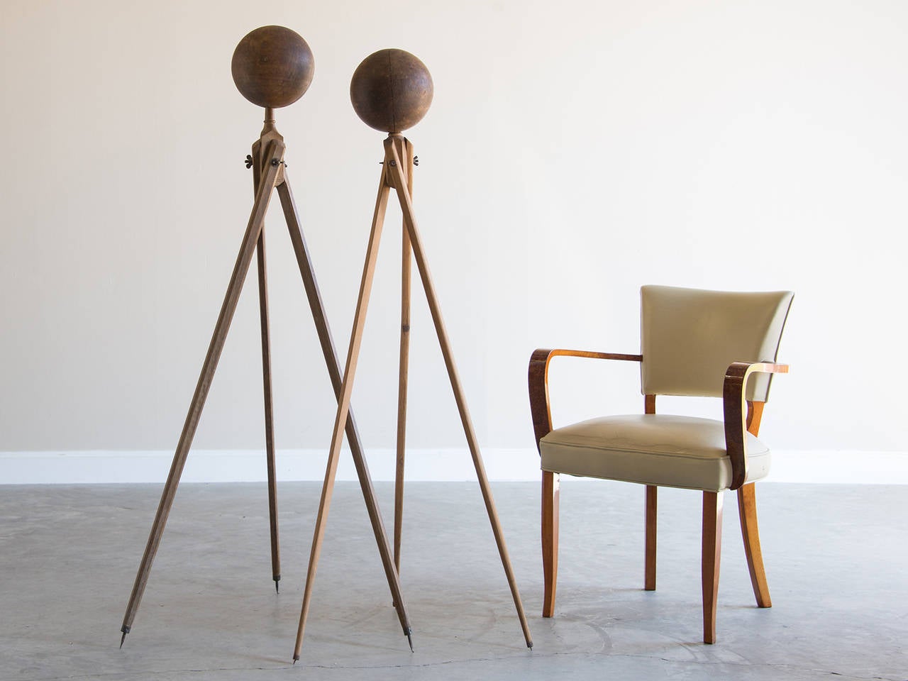 These intriguing sculptural objects possess a unique visual allure. The two vintage tripods were used by surveyors when measuring distance but have now been fitted with hand hewn spheres of solid timber. The warmth of the wood is quite alluring and