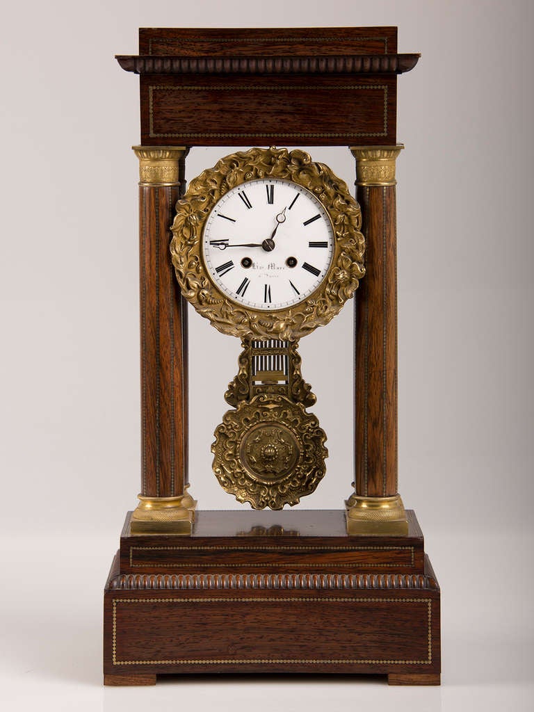 Receive our new selections direct from 1stdibs by email each week. Please click Follow Dealer below and see them first!

An antique French Charles X period Rosewood and Ormolu Portico clock circa 1830. The handsome proportions and neoclassical