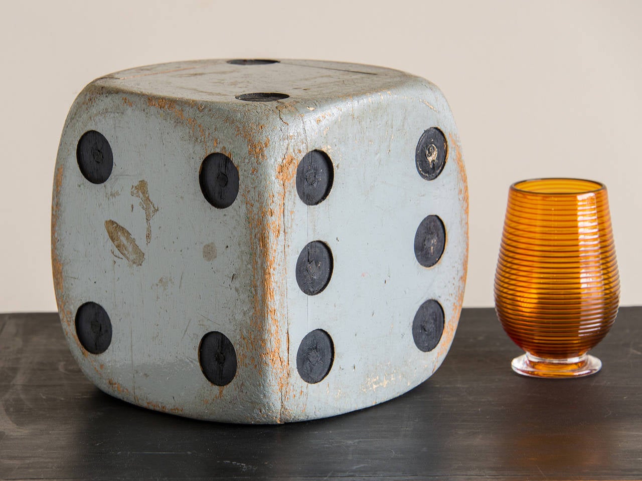 A vintage large scale painted wood die from France c.1940.  This die (individual term for the multiple dice) was originally used in a gaming establishment or a shop that specialized in games of chance as a display piece designed to galvanize